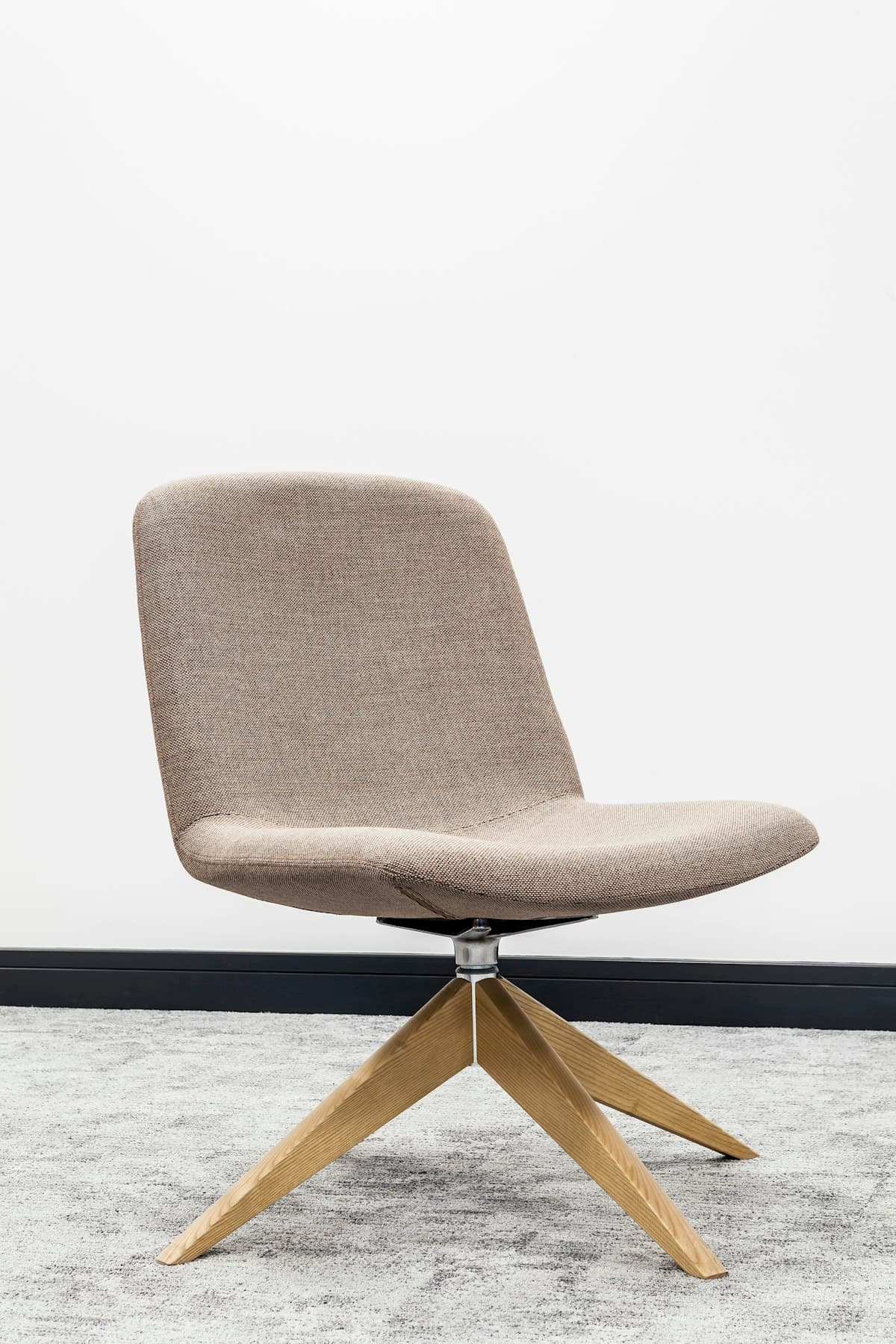 Premium ergonomic black mesh office chair with aluminium frame in a minimalist studio
