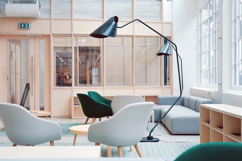 Sleek matte white under-desk mobile pedestal with silver handle in a modern workspace