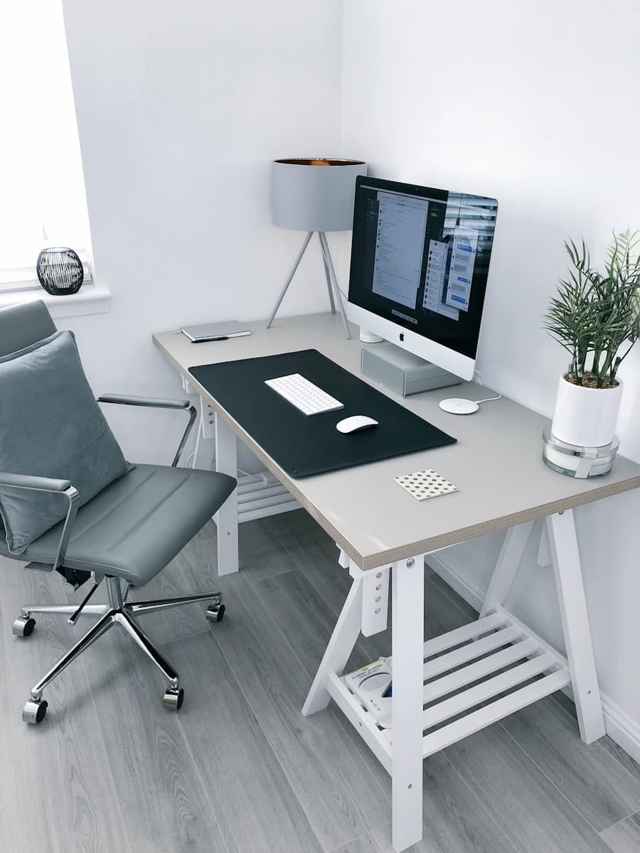 Minimal L-shaped executive desk in walnut wood with clean cable management
